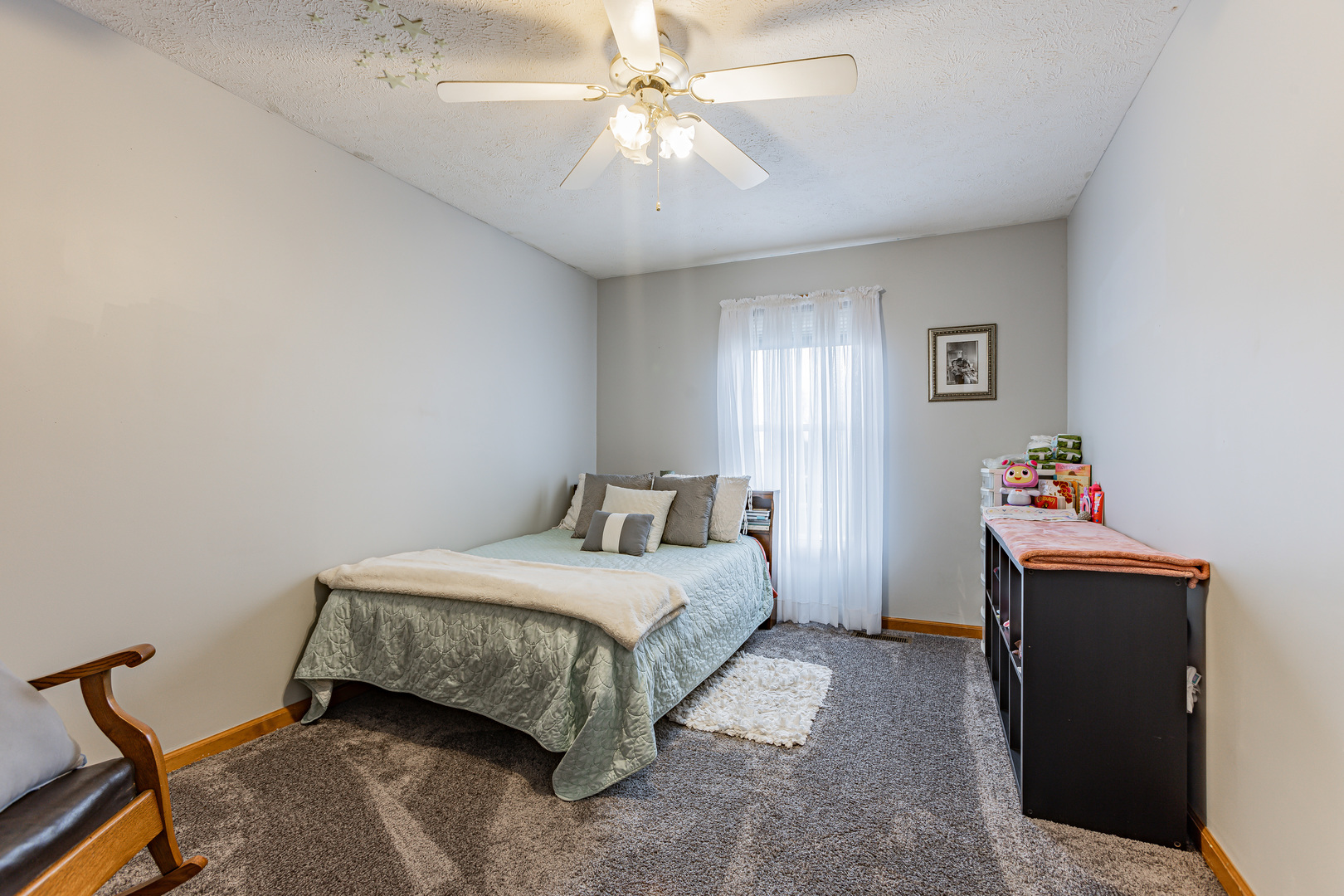 4401 Copper Ridge Road Champaign, IL 61822 - Photo 33 of 49 a bedroom with a bed and a chandelier