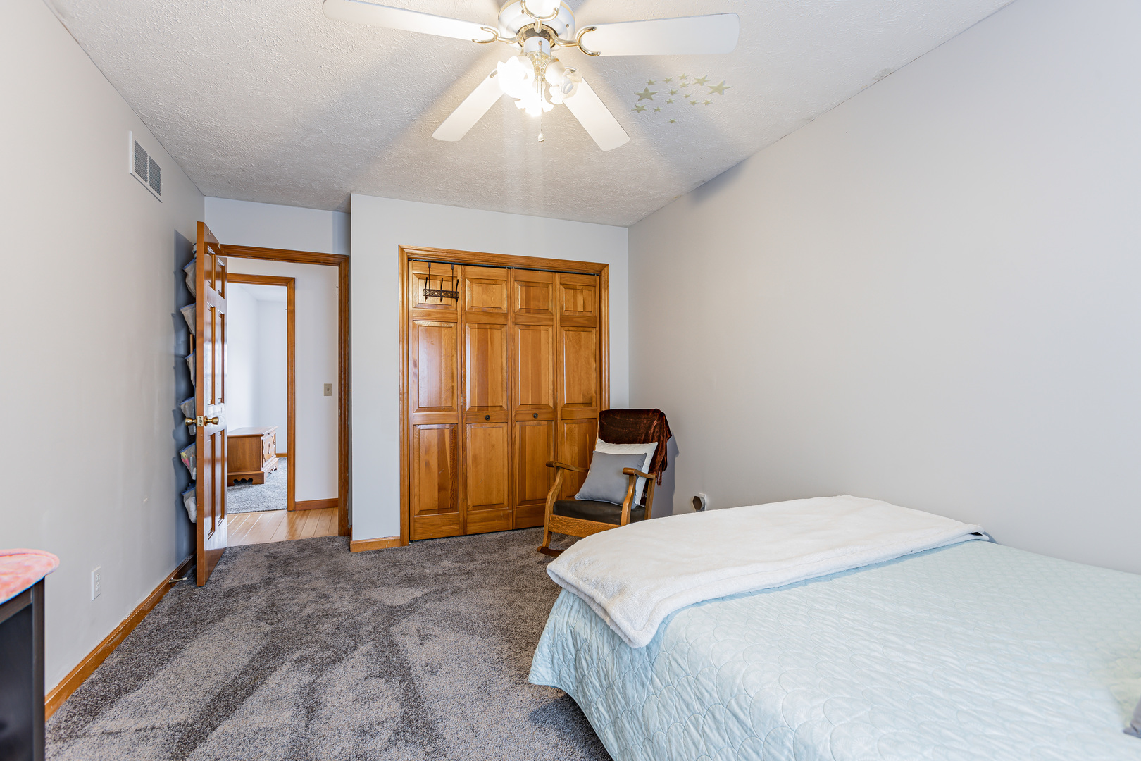 4401 Copper Ridge Road Champaign, IL 61822 - Photo 34 of 49 a bedroom with a bed and a chandelier