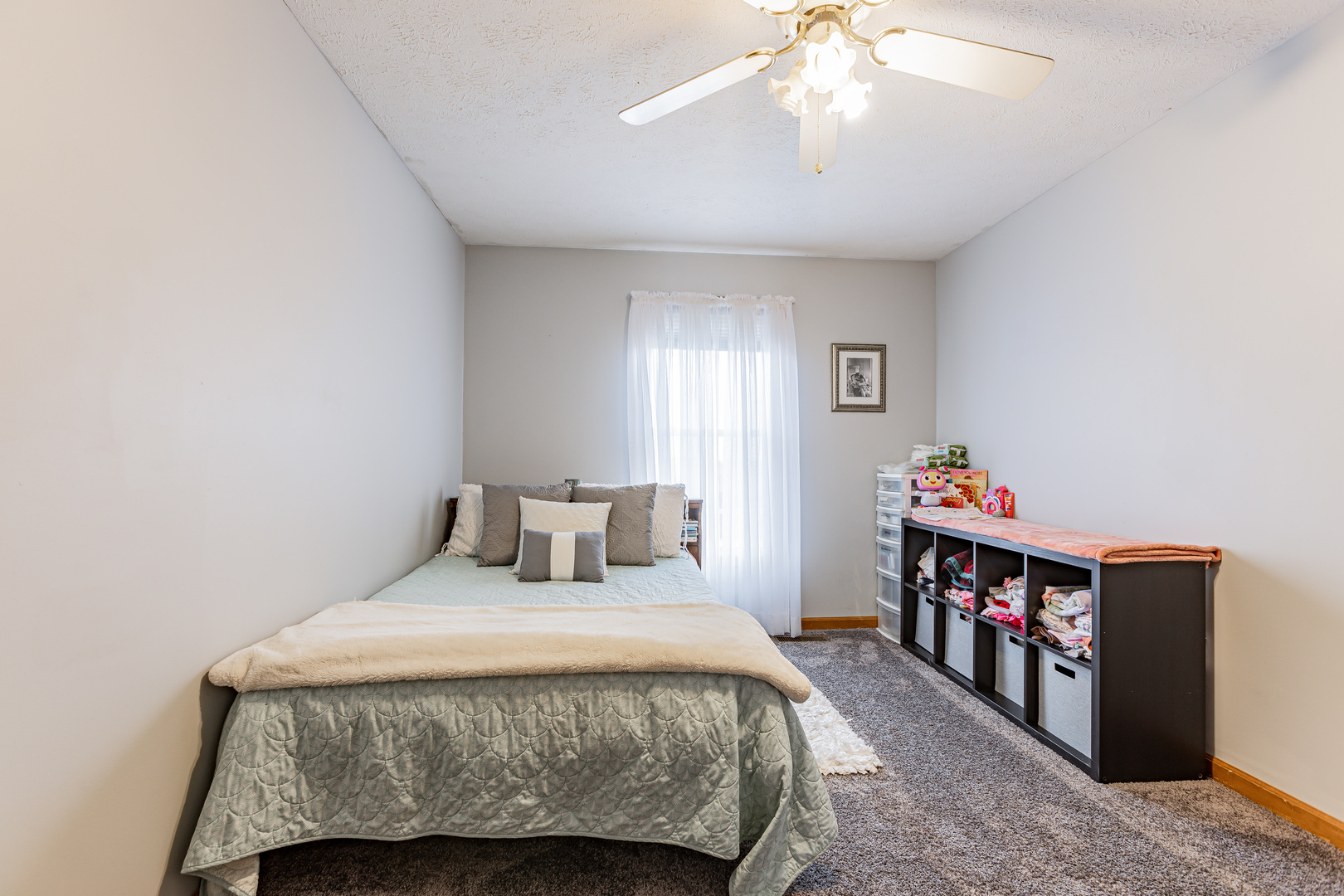 4401 Copper Ridge Road Champaign, IL 61822 - Photo 35 of 49 a bedroom with a bed and a chandelier