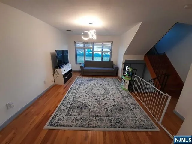 a view of a livingroom with furniture and staircase