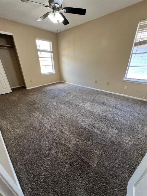 4106 Rippling Creek Drive Corpus Christi, TX 78410 - Photo 11 of 22 en empty room with windows and chandelier fan