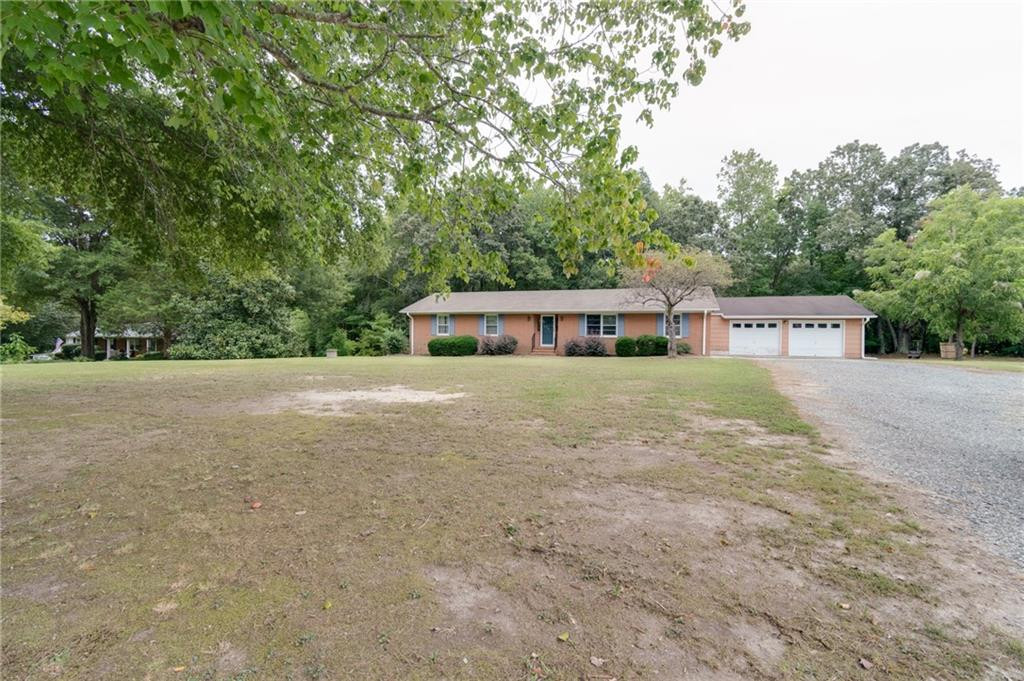 6533 Monnett Road Climax, NC 27233 - Photo 2 of 13 a house view with a garden space