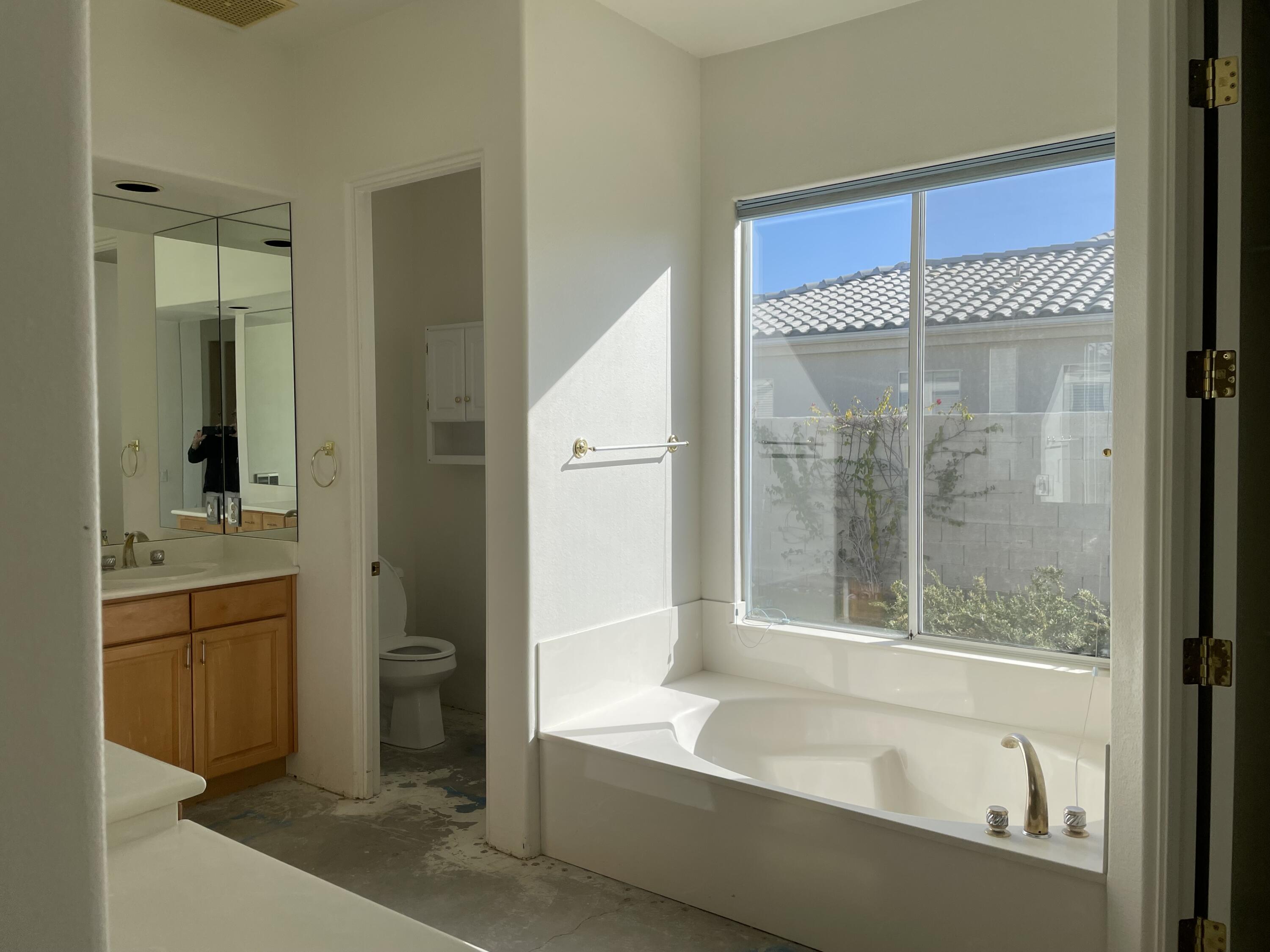 3 King Edward Court Rancho Mirage, CA 92270 - Photo 11 of 20 a bathroom with a granite countertop sink mirror bathtub and toilet