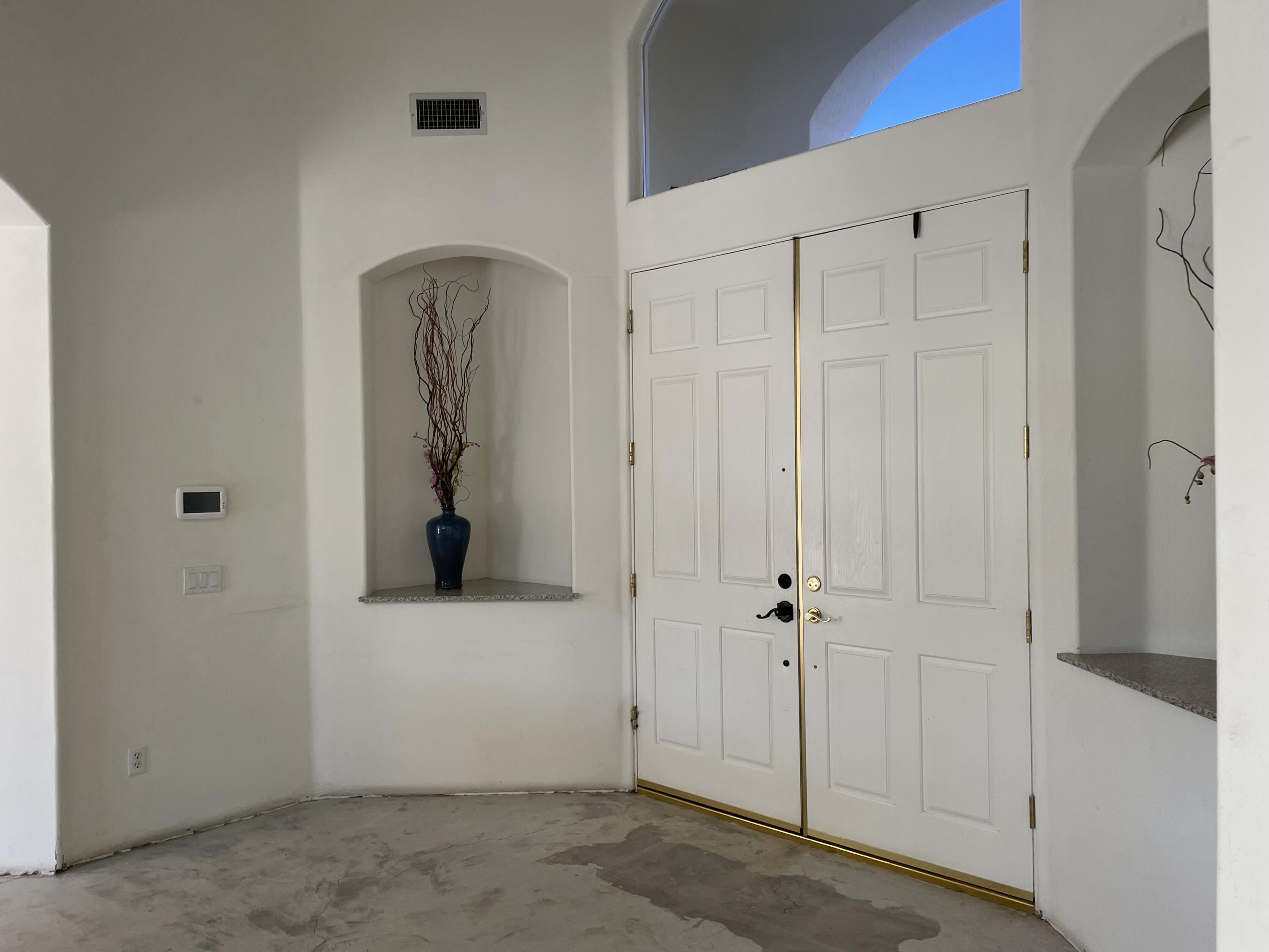3 King Edward Court Rancho Mirage, CA 92270 - Photo 3 of 20 a view of a hallway with wooden floor and closet