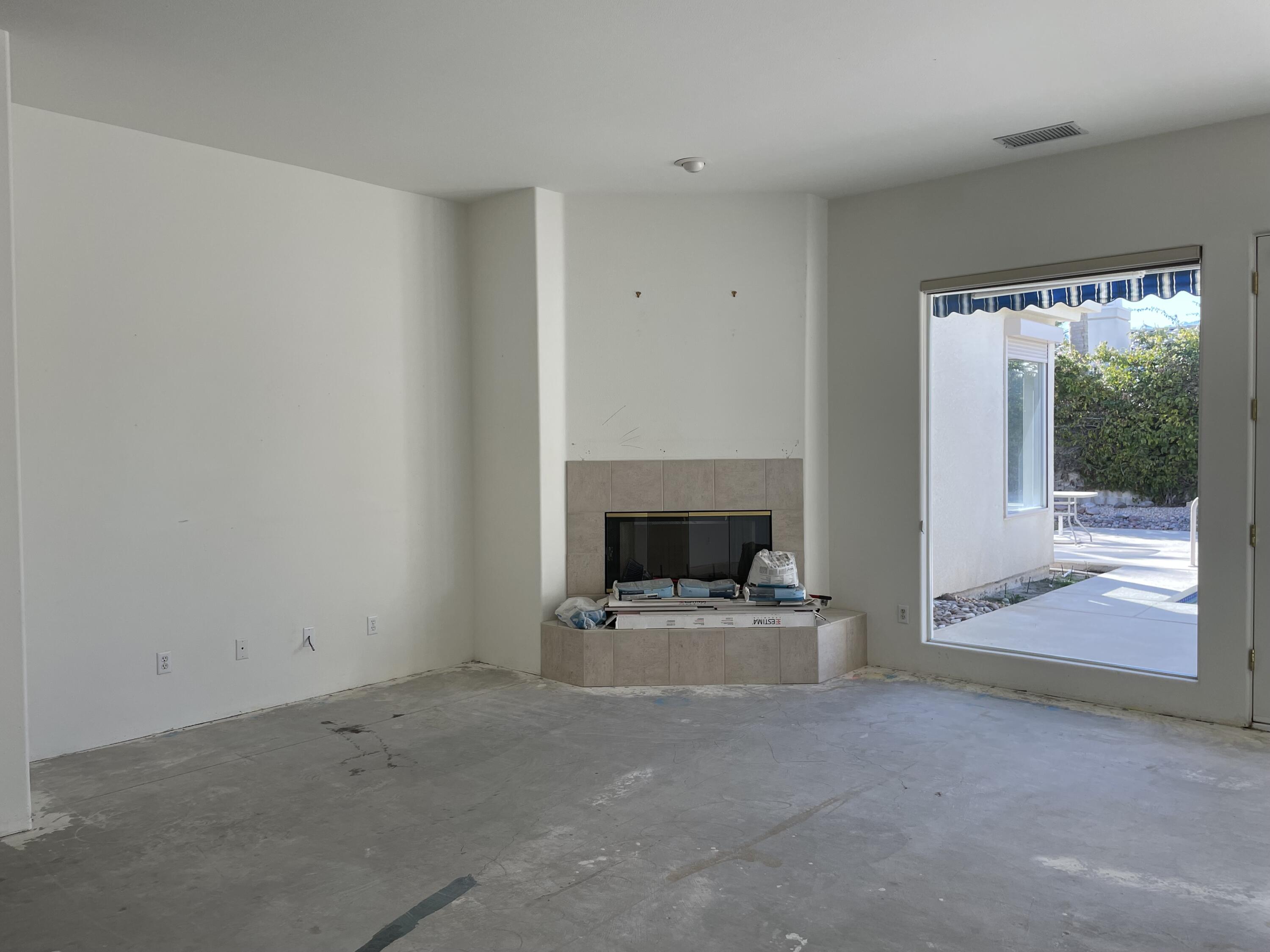 3 King Edward Court Rancho Mirage, CA 92270 - Photo 4 of 20 a view of empty room with fireplace and fan