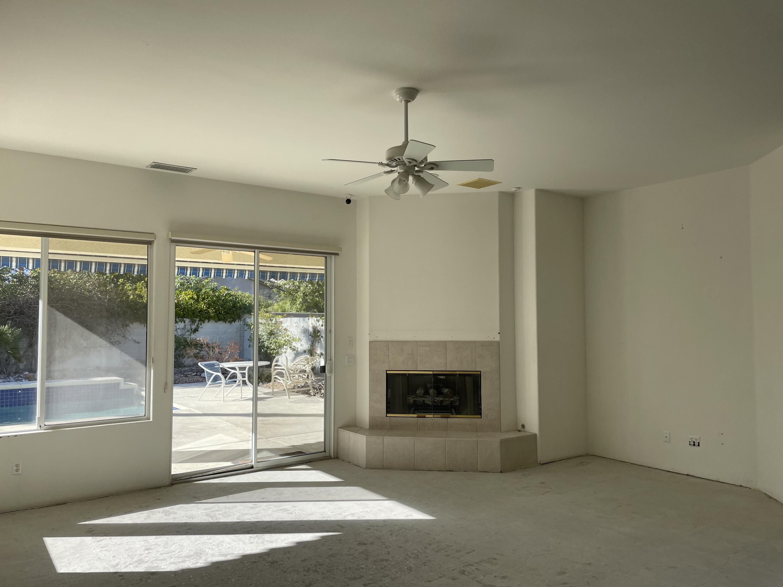 3 King Edward Court Rancho Mirage, CA 92270 - Photo 5 of 20 a living room with a fireplace and a fireplace