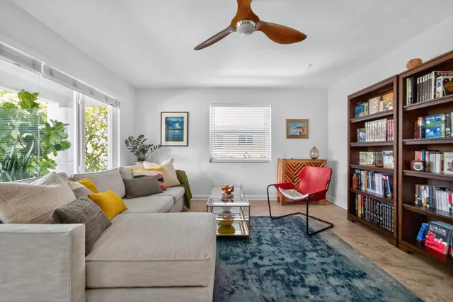 a living room with furniture workspace and a window