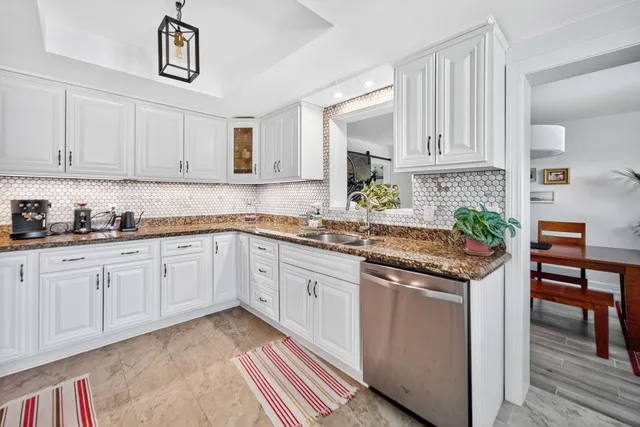 a kitchen with stainless steel appliances granite countertop a sink and cabinets
