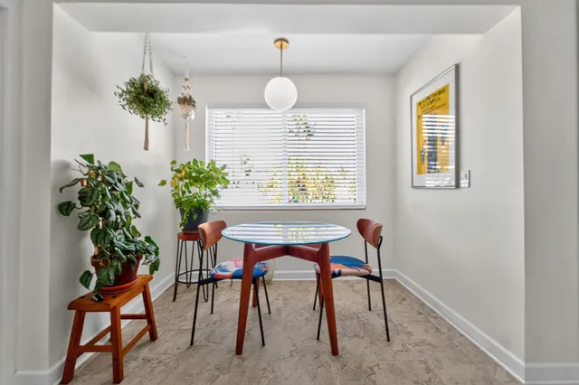 a dining room with furniture and window