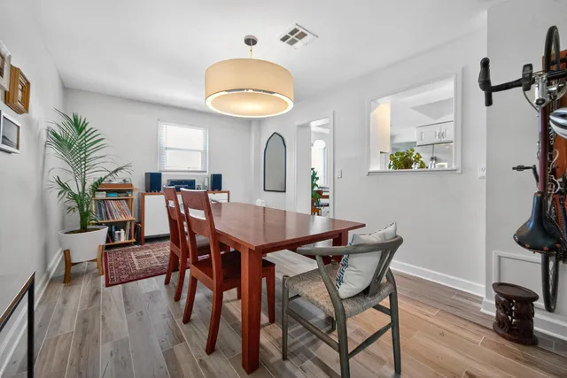 a view of a dining room with furniture and wooden floor