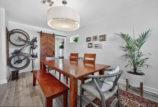 a view of a dining room with furniture and wooden floor