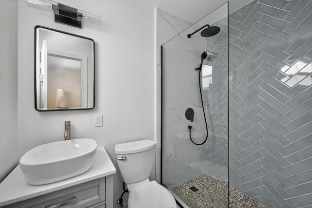 a bathroom with a toilet sink and shower