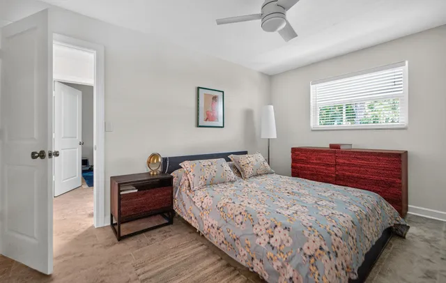 a bedroom with bed and window