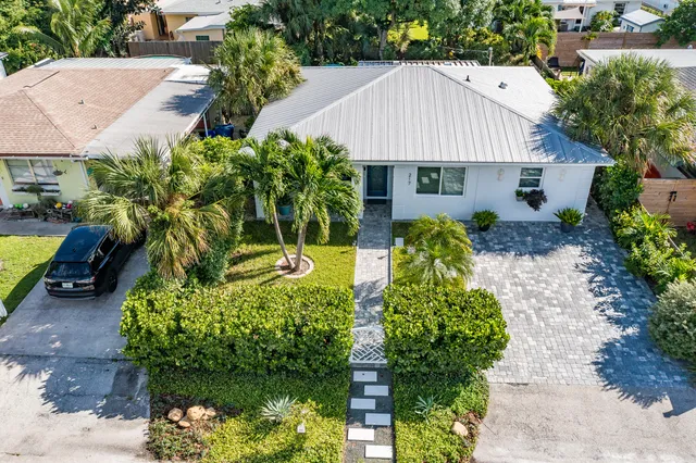 a aerial view of a house with a yard and potted plants
