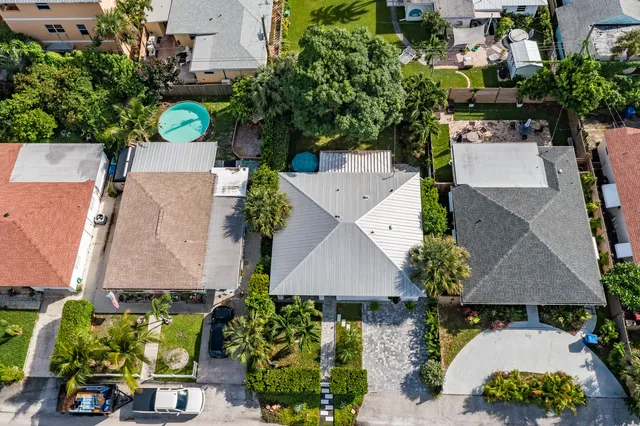 an aerial view of a house with a yard and garden