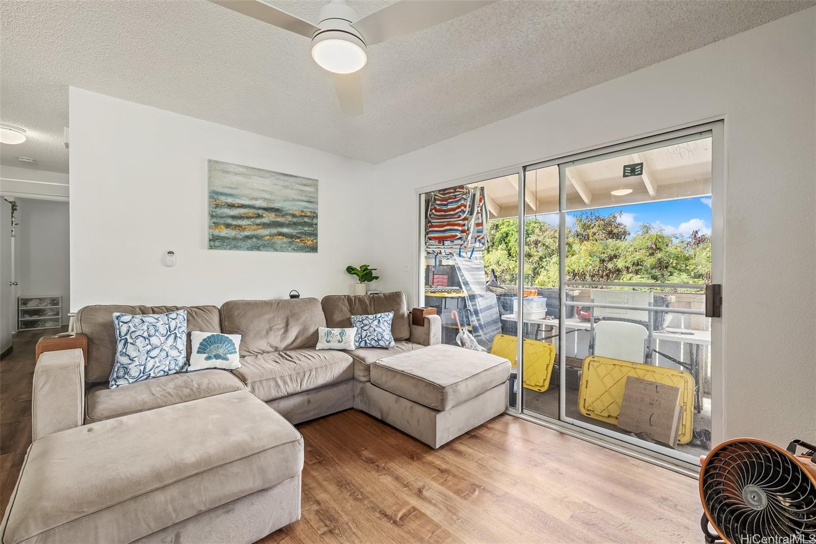 509 Mananai Place, Unit 33T Honolulu, HI 96818 - Photo 2 of 22 a living room with furniture and a large window