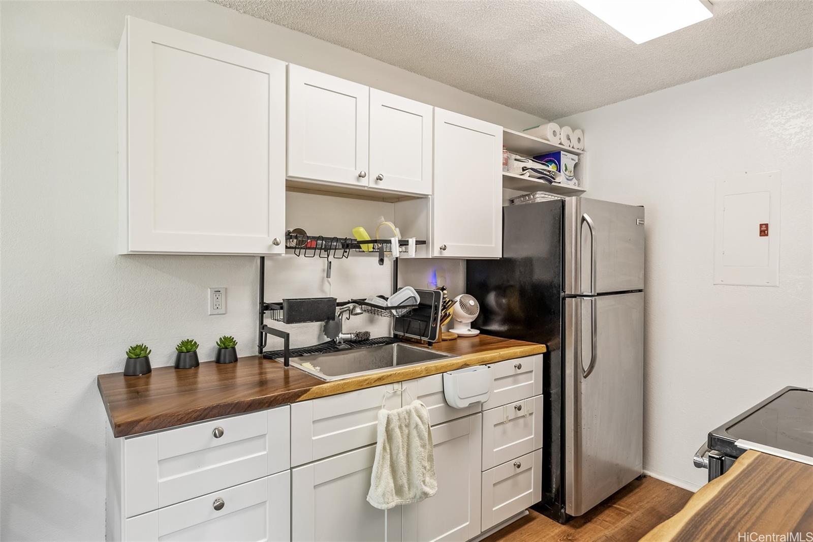 509 Mananai Place, Unit 33T Honolulu, HI 96818 - Photo 7 of 22 a kitchen with stainless steel appliances granite countertop a refrigerator sink and cabinets