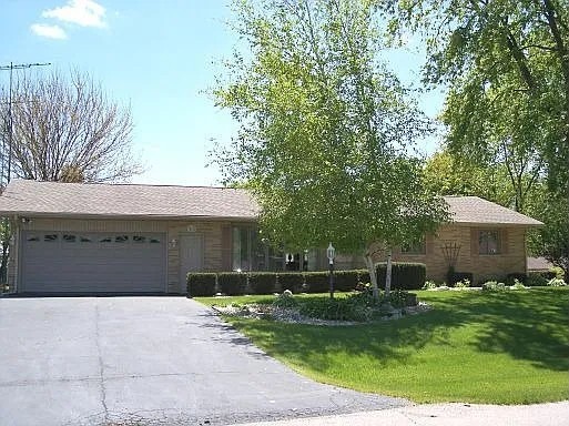 12628 Willow Lane Genoa, IL 60135 - Photo 1 of 21 a front view of a house with a yard