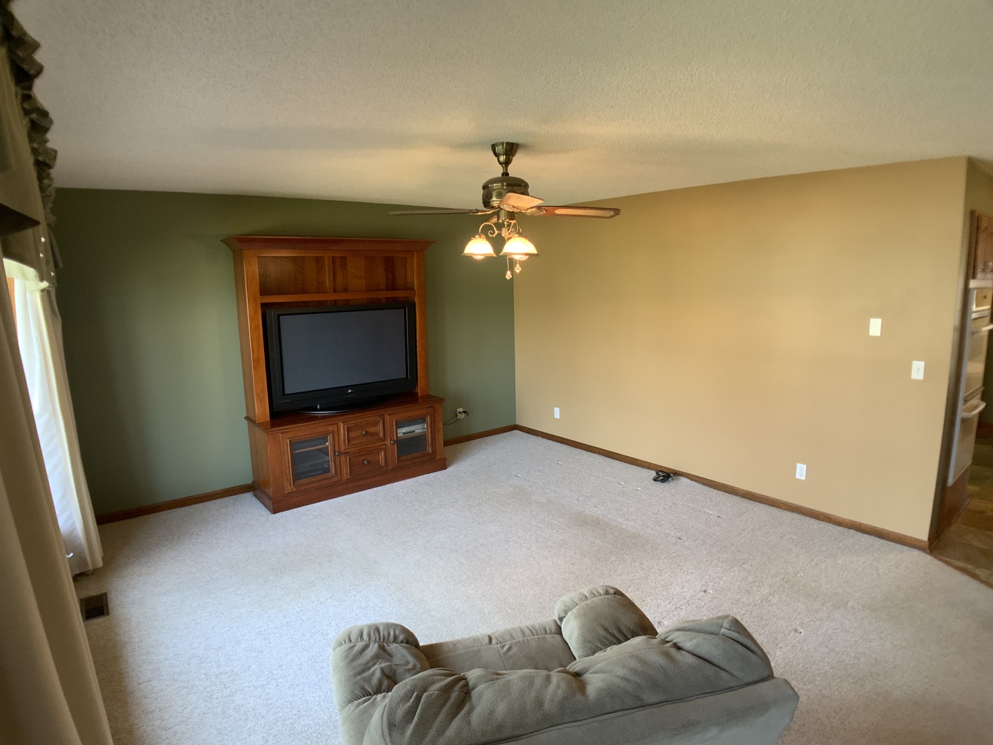 12628 Willow Lane Genoa, IL 60135 - Photo 2 of 21 a living room with furniture and a flat screen tv