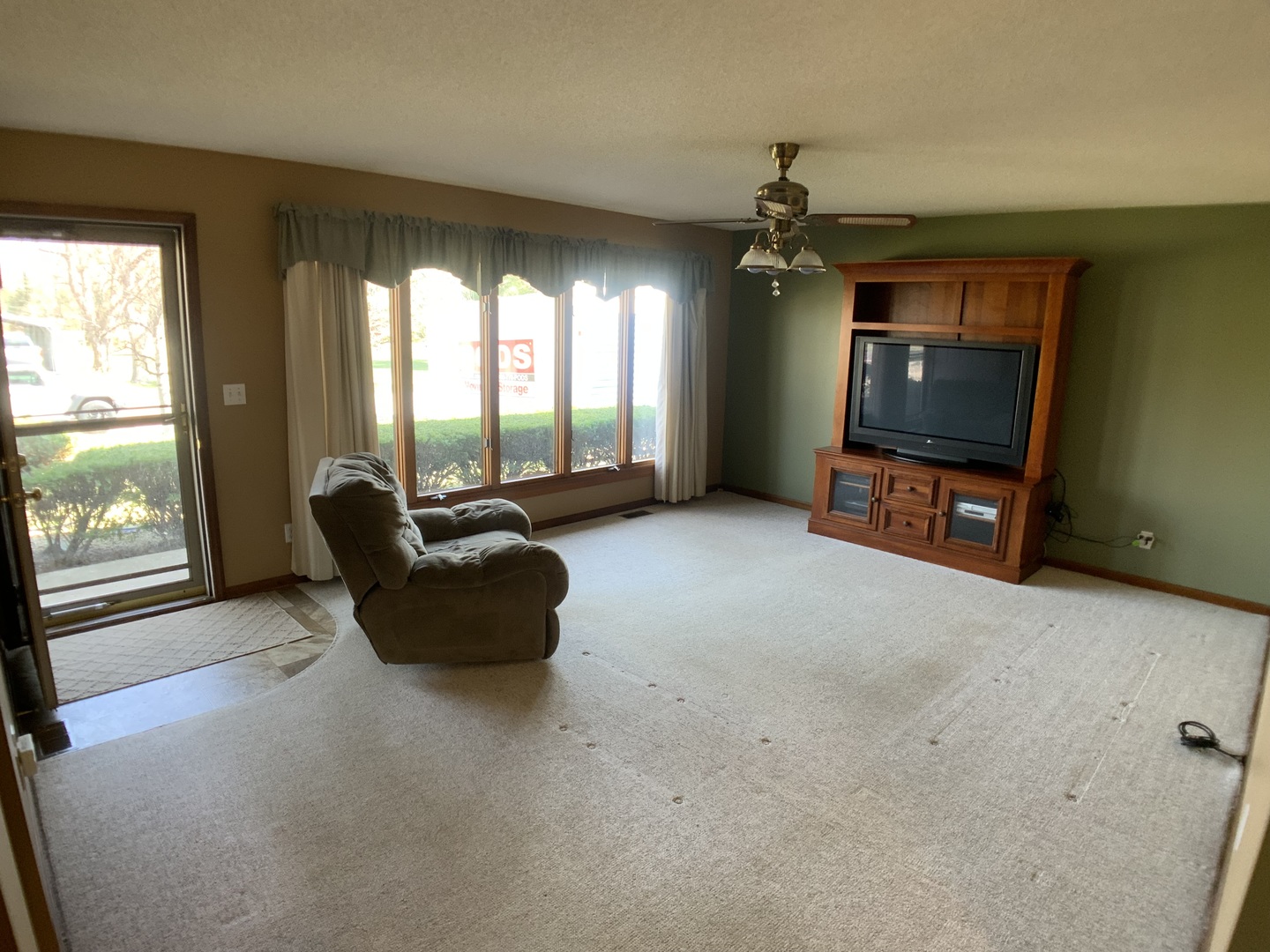 12628 Willow Lane Genoa, IL 60135 - Photo 4 of 21 a living room with furniture and a flat screen tv