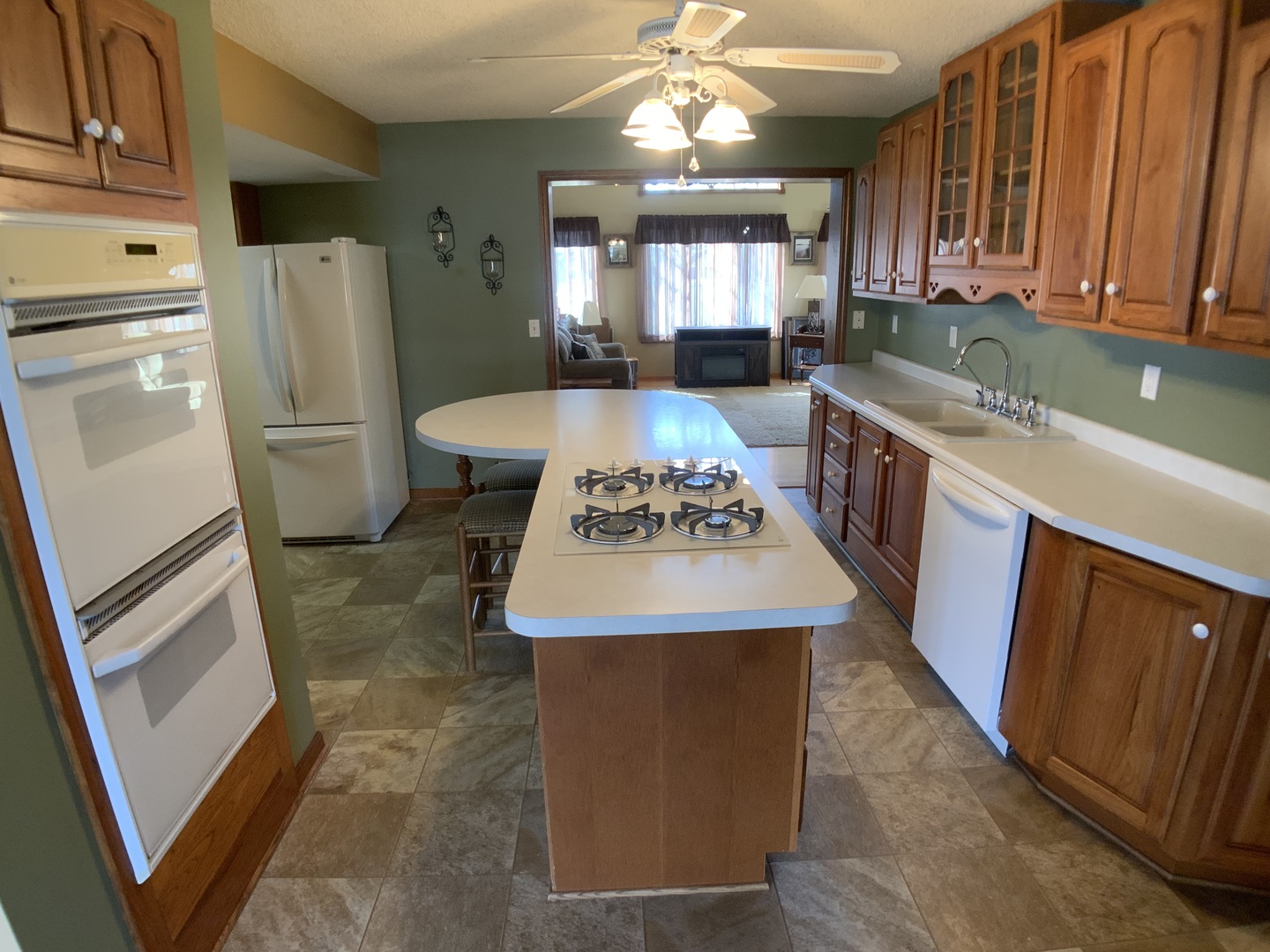 12628 Willow Lane Genoa, IL 60135 - Photo 5 of 21 a kitchen with stainless steel appliances granite countertop a refrigerator a sink a stove a washer dryer and a refrigerator