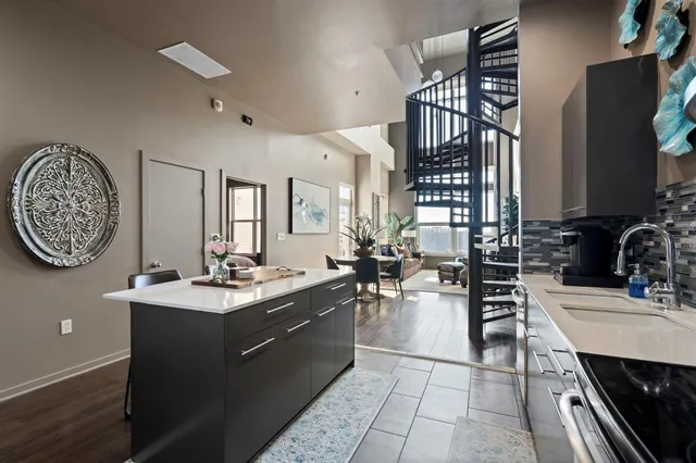 a kitchen with a sink appliances and cabinets