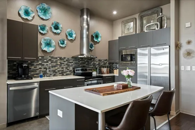 a kitchen with stainless steel appliances a counter space and a window