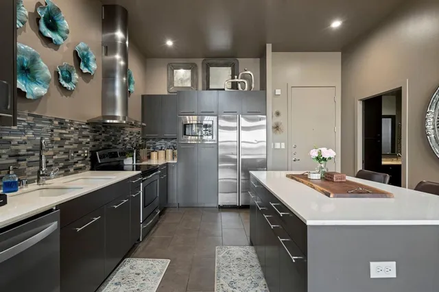 a kitchen with a sink stove and refrigerator