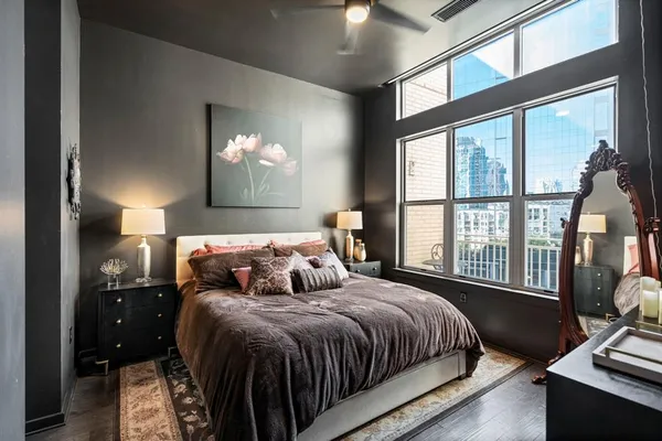 a bedroom with a bed next to a window