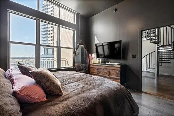 a bedroom with a bed and a flat screen tv