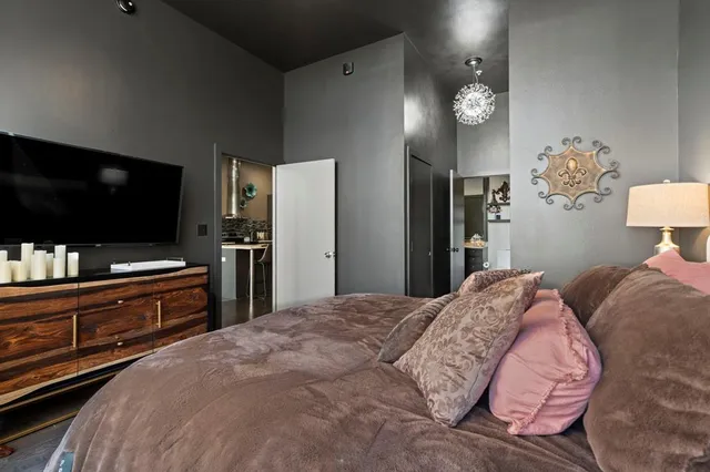 a bedroom with a bed and a flat screen tv