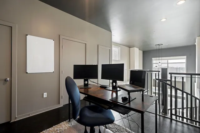 a view of a workspace with furniture and a window