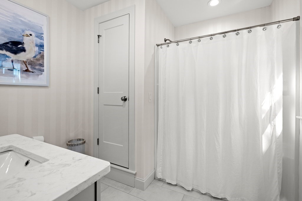 12 Big Rock Road Rye, NH 03870 - Photo 26 of 42 a bathroom with a sink and a shower