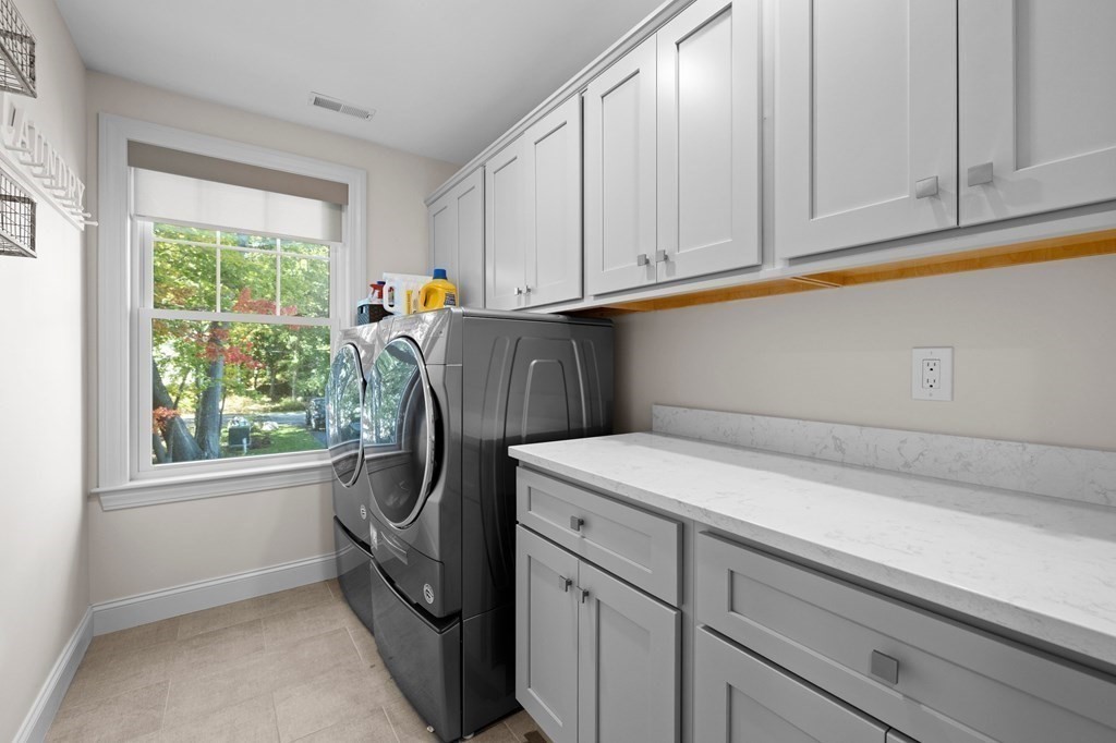 12 Big Rock Road Rye, NH 03870 - Photo 27 of 42 a utility room with wooden floor washer and dryer