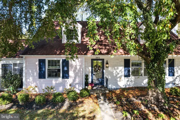front view of a house with a large tree