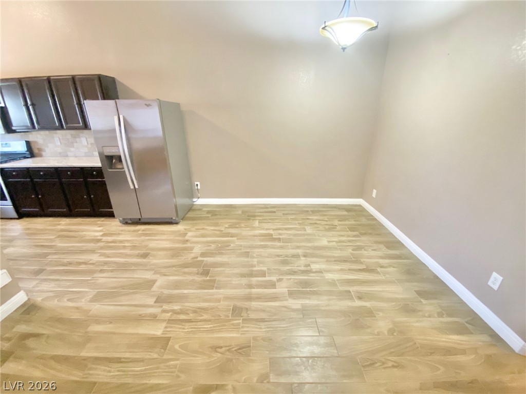2000 Turquoise Ridge Street, Unit 204 Las Vegas, NV 89117 - Photo 13 of 29 The seamless wood-look tile flooring connects the kitchen area with its dark cabinetry and stainless steel appliances.