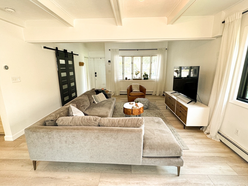 101 Spiers Road Newton, MA 02459 - Photo 13 of 35 a living room with furniture and a flat screen tv