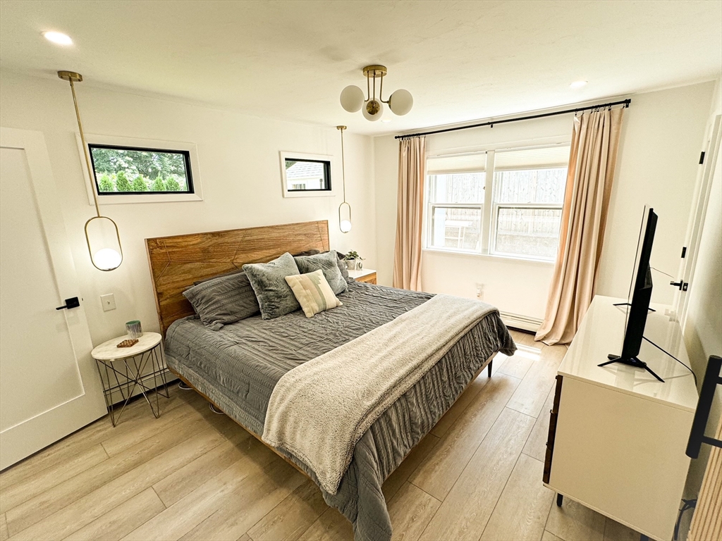 101 Spiers Road Newton, MA 02459 - Photo 18 of 35 a bedroom with a bed a window and dresser