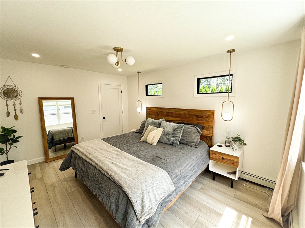 101 Spiers Road Newton, MA 02459 - Photo 19 of 35 a bedroom with a bed and wooden floor