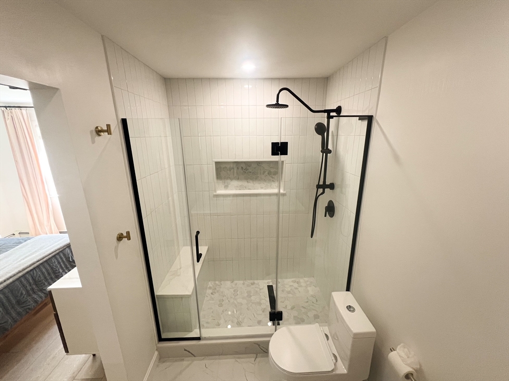 101 Spiers Road Newton, MA 02459 - Photo 22 of 35 a bathroom with a granite countertop sink toilet and shower