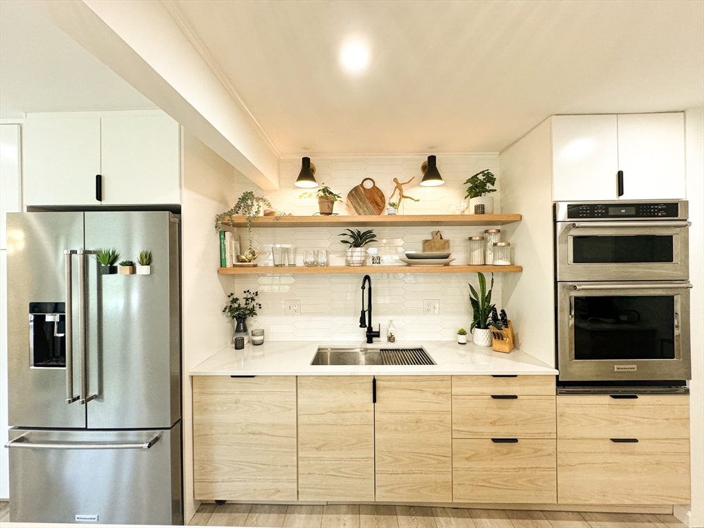 101 Spiers Road Newton, MA 02459 - Photo 6 of 35 a kitchen with stainless steel appliances kitchen island granite countertop a refrigerator and a stove