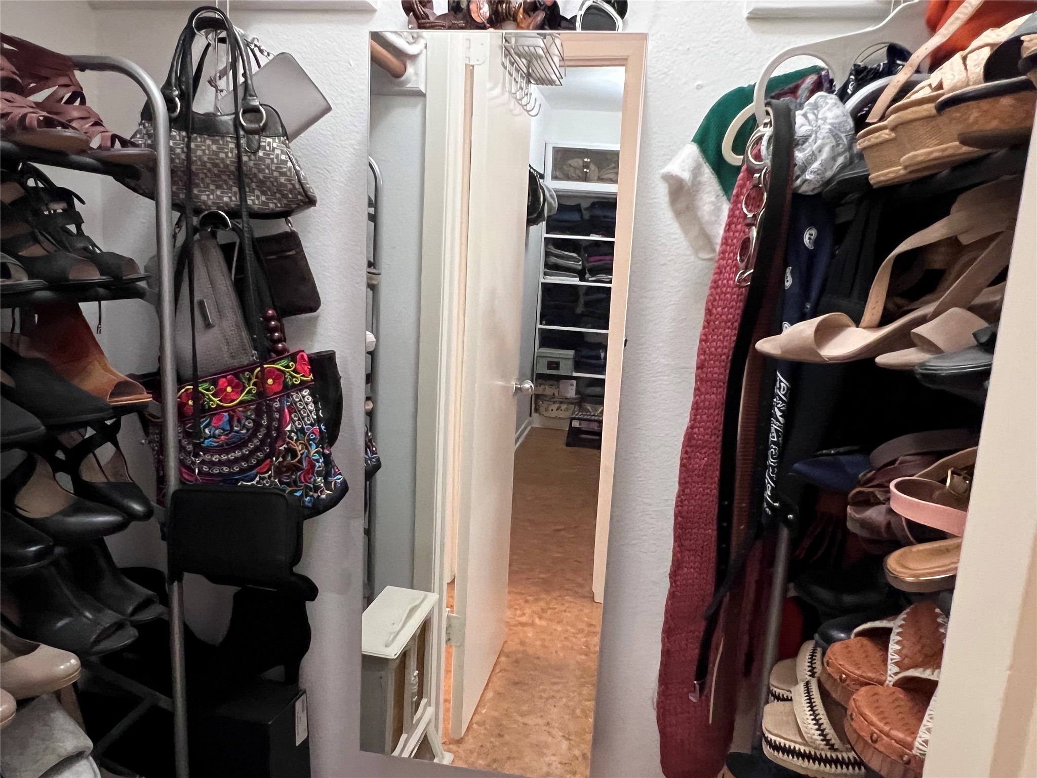 2100 Commonwealth Street, Unit L Houston, TX 77006 - Photo 23 of 30 a view of walk in closet with clothes and shoes