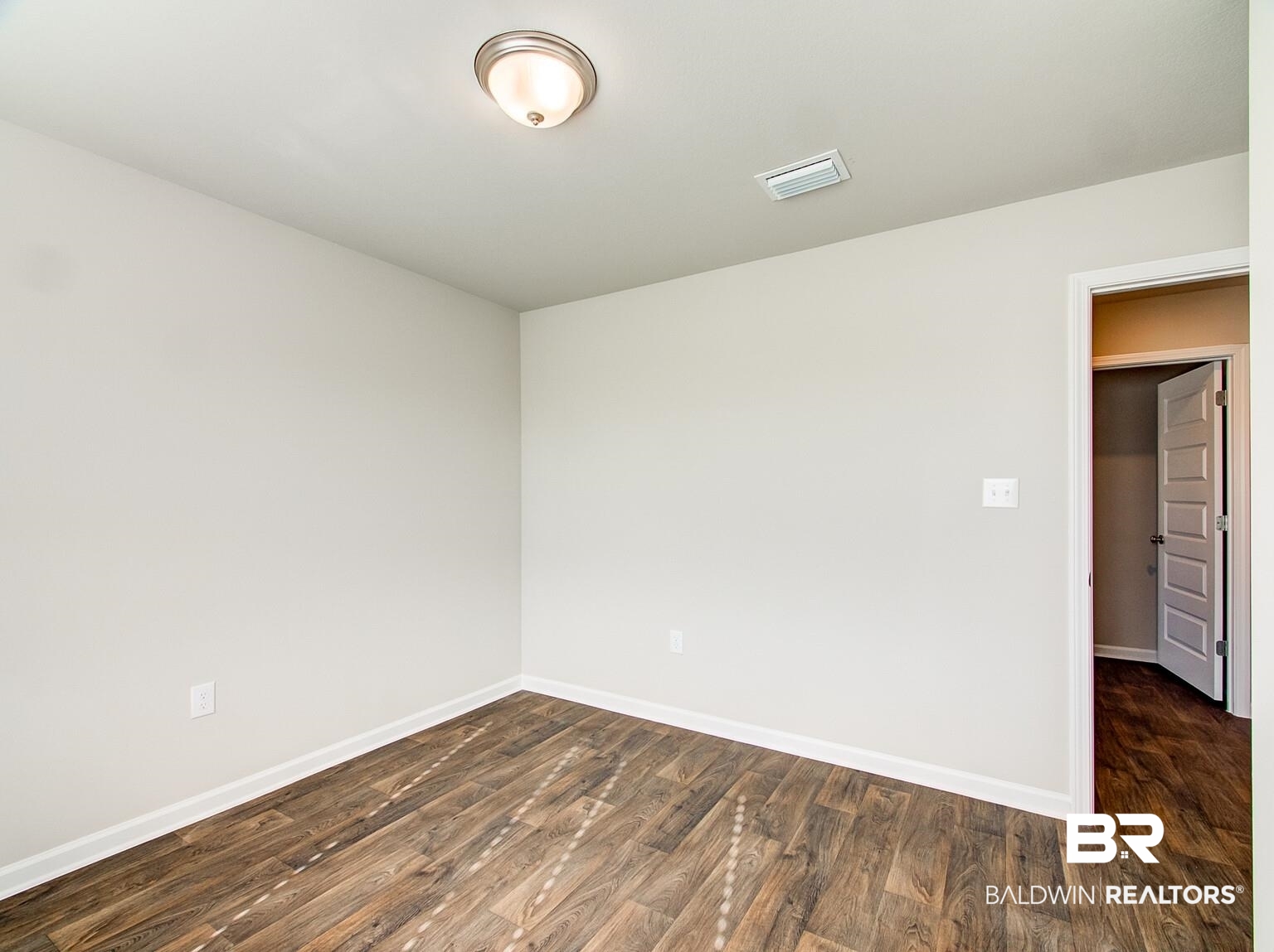 23953 Citation Loop Daphne, AL 36526 - Photo 25 of 49 Unfurnished room featuring dark wood finished floors and baseboards