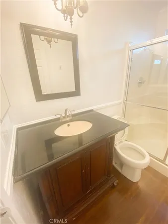 a bathroom with a sink toilet and mirror