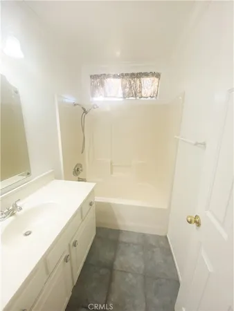 a bathroom with a bathtub sink and mirror