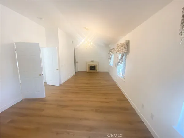a view of empty room with a fireplace
