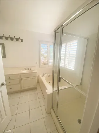 a bathroom with a sink mirror and a shower