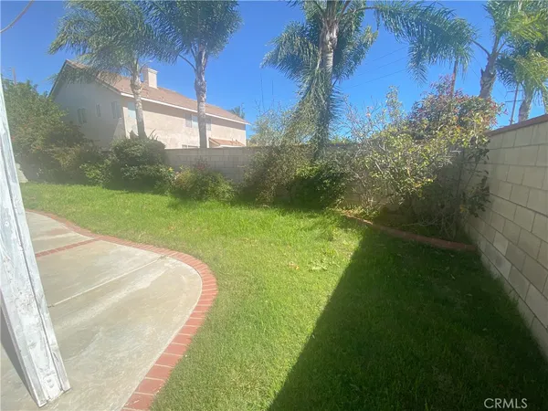 a view of a garden with a building in the background