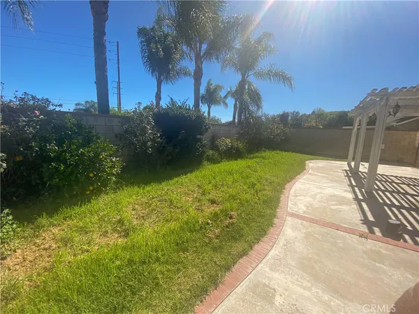 a view of a brick house with a yard