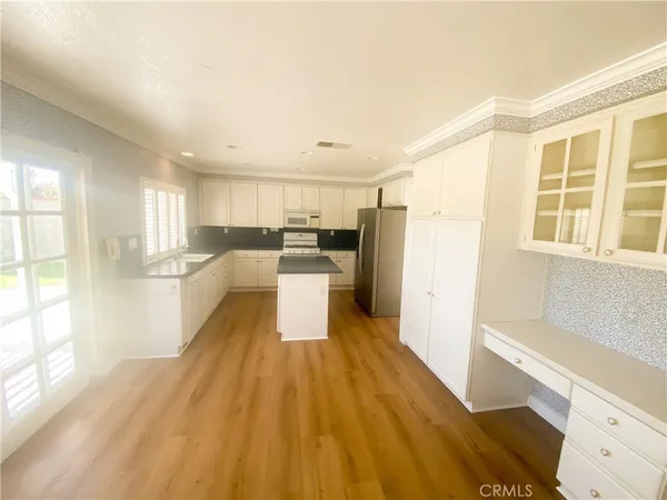 a view of a kitchen with wooden floor